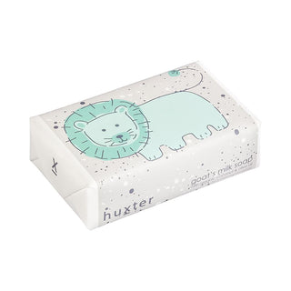 Huxter's Natural Goat's Milk Soap with green lion and organic coconut and olive oil wrapped in white spots.
