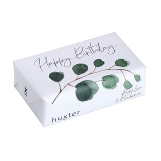 Huxter's Natural Basil, Lime, & Mandarin soap wrapped in 'Green Leaves' with white cover.