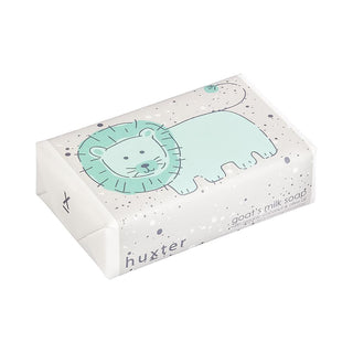 Huxter's Natural Goat's Milk Soap with green lion and organic coconut and olive oil wrapped in white spots. 